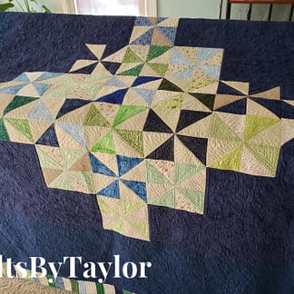 Handmade Pinwheel Quilt with free motion spiral quilting in bright cotton fabrics