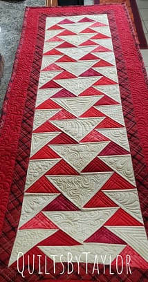Quilts For Sale/ Quilt for Sale/ Quilt for Sale Handmade Handmade Quilts/ Close-up of red, Flying Geese quilt blocks with detailed free-motion quilting stitches.