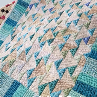 Teal Flying Geese accent quilt for farmhouse kitchens