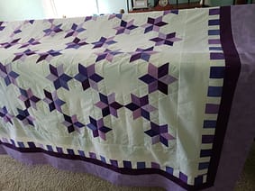 Quilts For Sale quilts for sale /The Tulip Trails quilt fully spread, highlighting its balanced tulip design and soft cotton fabric.