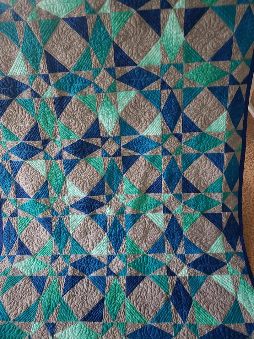 Quilts For Sale/ Quilt for Sale/ Quilt for Sale Handmade Quilts for Sale/Close-up view of free-motion quilting details on a multi-color handmade Storm At Sea quilt